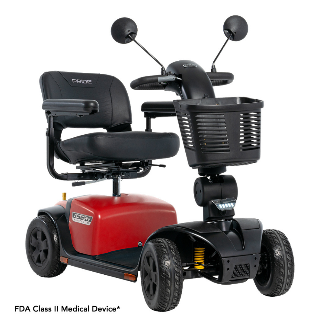 A red and black Pride Mobility Victory® Platinum Bariatric 4-Wheel Scooter with cushioned seat, armrests, front basket, rearview mirrors, and FDA Class II rating. Features EZ Turn Technology for better maneuverability.